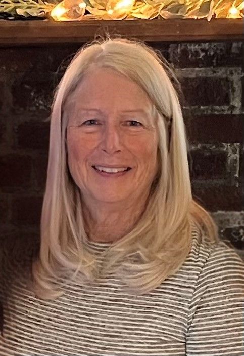 Photo of Janet, our office secretary, smiling.