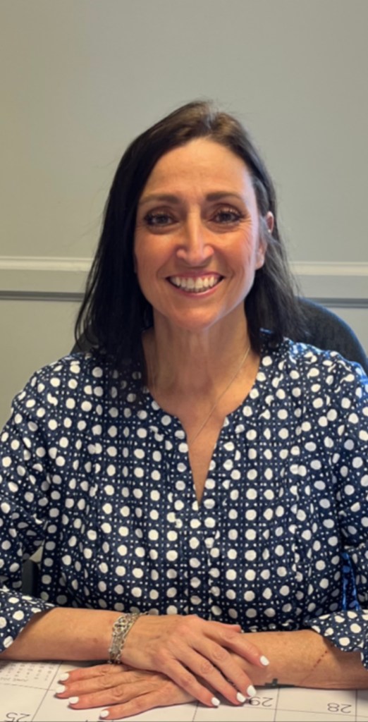 Photo of Mandi Sisk, preschool director, smiling at the camera